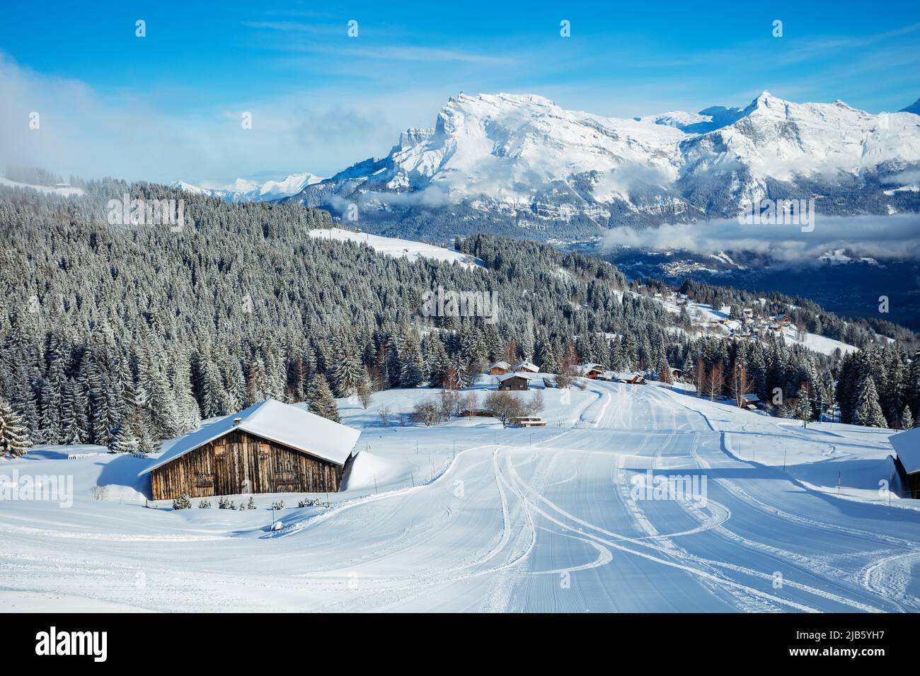 Covered by snow houses after snowfall and fresh ski track Stock Photo