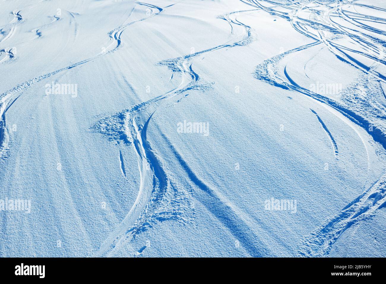 Traces of ski and snowboard in the snow view from above Stock Photo