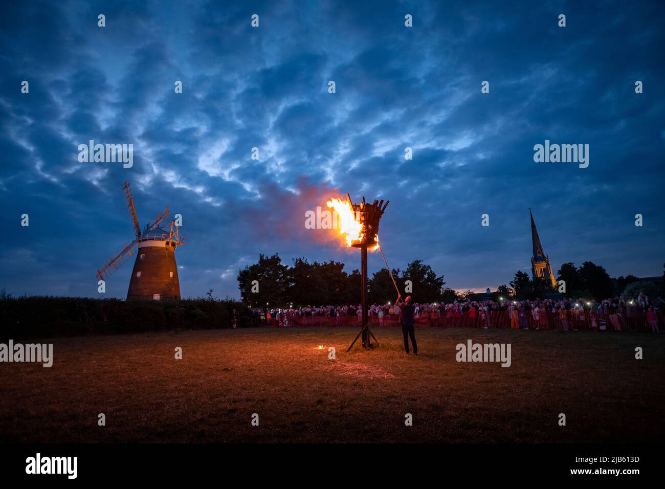Thaxted, UK. 02nd June, 2022. Thaxted Essex UK Platinum Jubilee Beacon Lighting Ceremony and Fireworks 2 June 2022 Late evening in Thaxted as the Beacon, one of 700 nationwide, is lit to celebrate Her Majesty Queen Elizabeth II's Platinum Jubilee, 70 years on the throne in the shadow of John Webbs 18th century Windmill and the 13th century Thaxted Church. Credit: BRIAN HARRIS/Alamy Live News Stock Photo