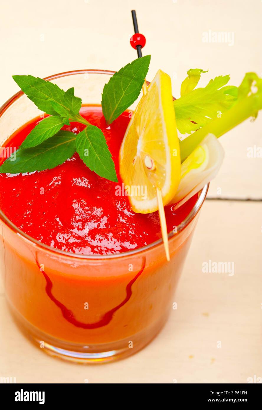 fresh tomato juice gazpacho soup on a glass over white wood table. Stock Photo