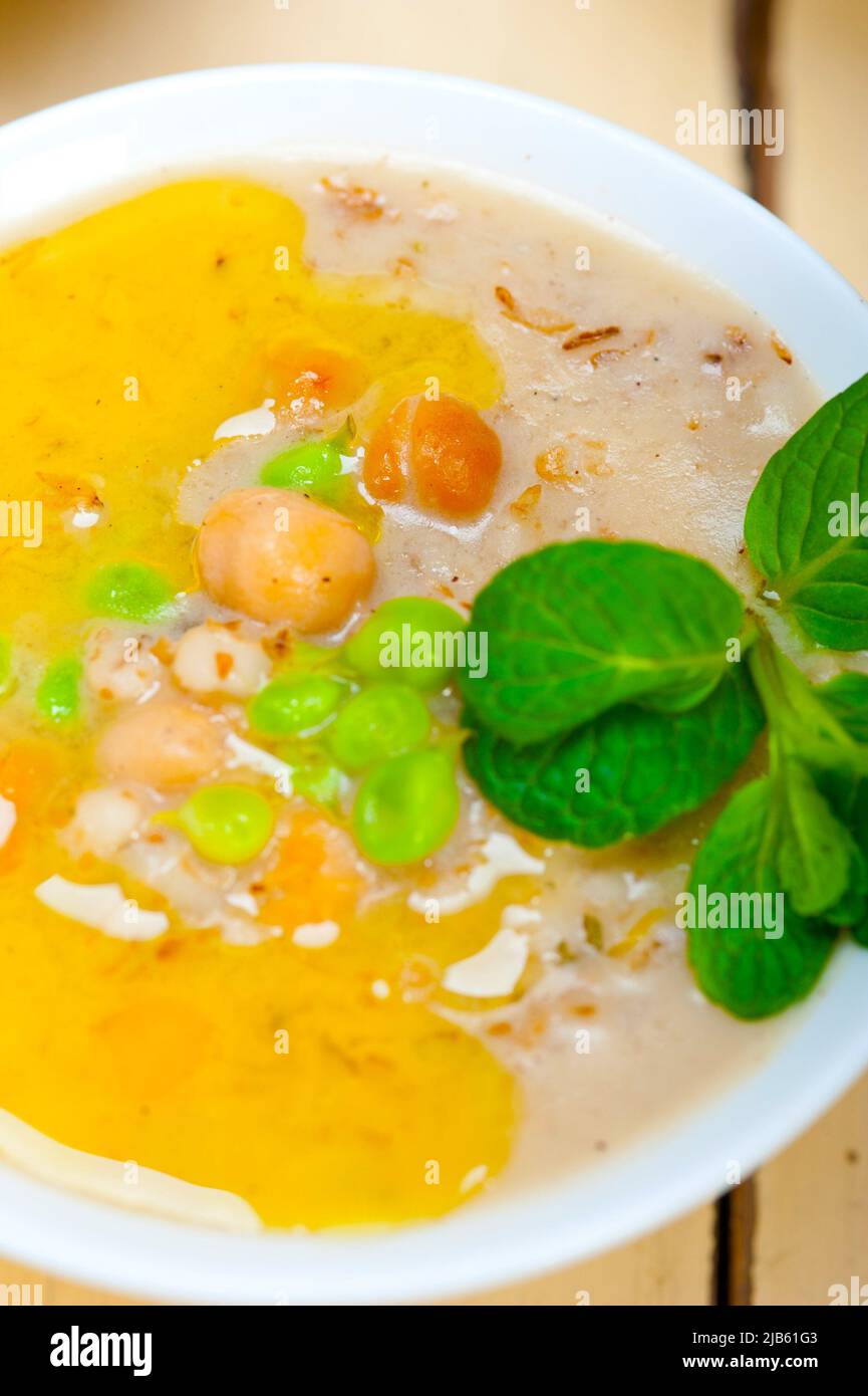 Hearty Middle Eastern Chickpea and Barley Soup with mint leaves on top. Stock Photo