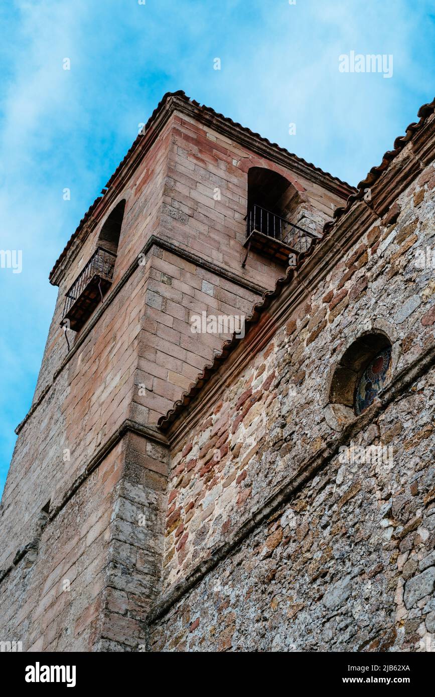 Bell tower of the church and Museum of Holy Trinity in the historic town of Atienza in Guadalajara, Spain. Low angle view against overcast sky. Stock Photo