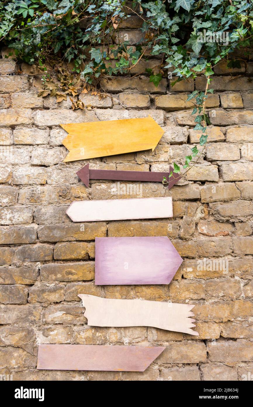 Wooden signs hanging on a rustic brick wall. Emty space, add text or