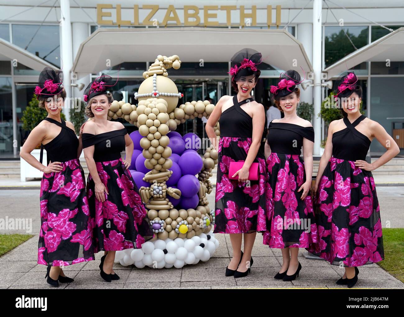 Elle and the Pocketbelles stand next to a crown made with balloons in
