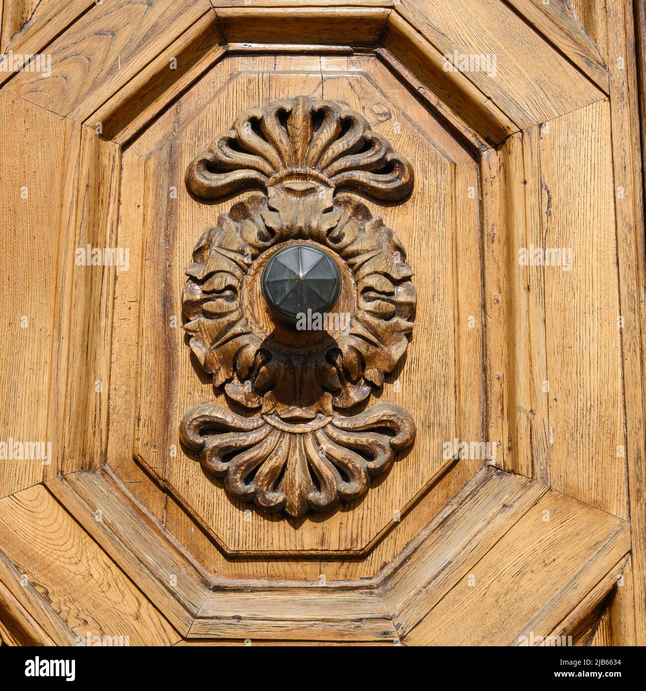 Ancient solid wood doors with hand-carved decorations by local artists, in the splendid historic center of Lucca Stock Photo