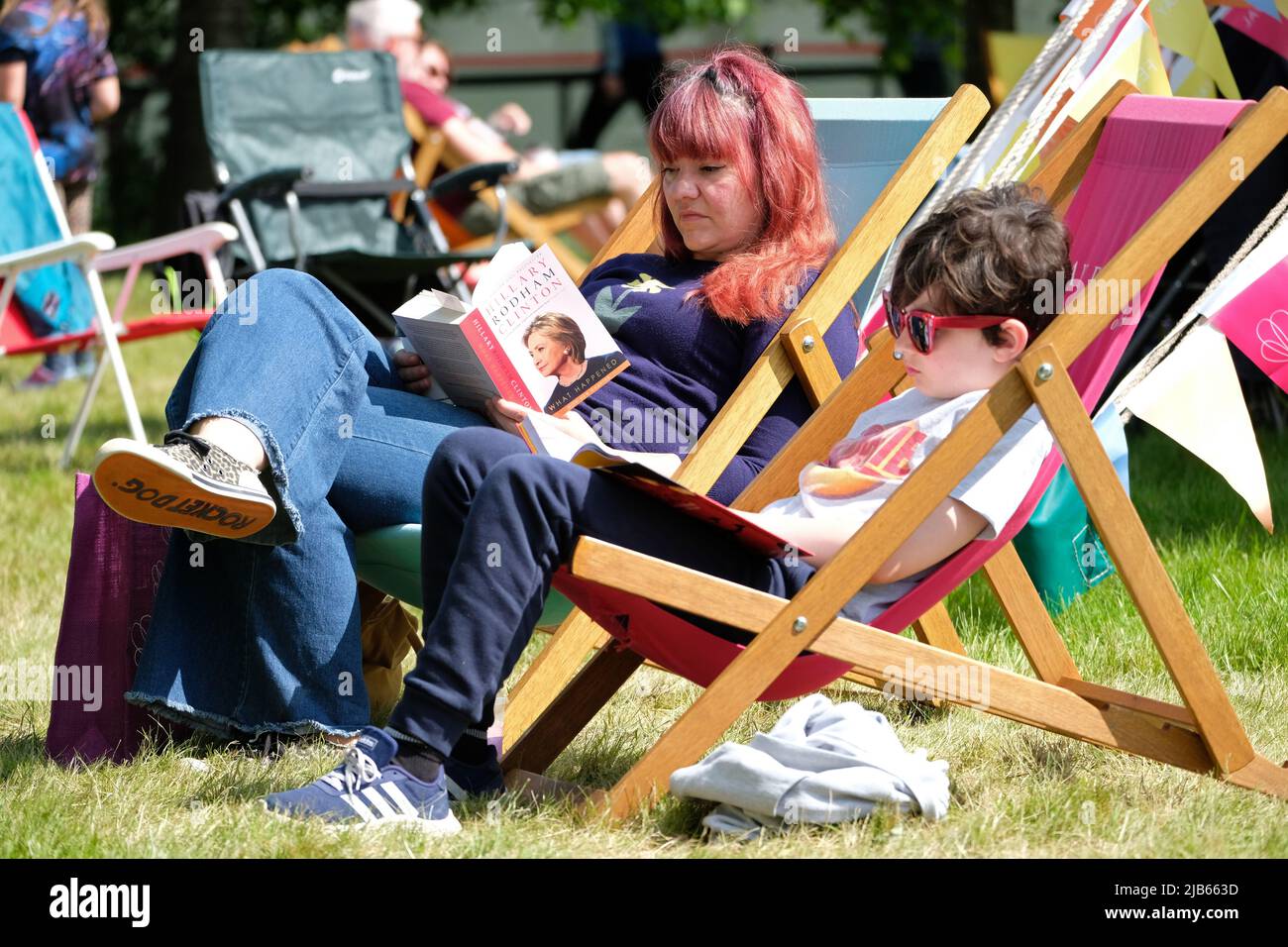 Hay Festival, Hay on Wye, Wales, UK – Friday 3rd June 2022 – Visitors to Hay enjoy a chance to read and relax on the Festival Lawns between events at the first in person Hay Festival since 2019 – The Hay Festival runs until Sunday 5th June 2022. Photo Steven May / Alamy Live News Stock Photo