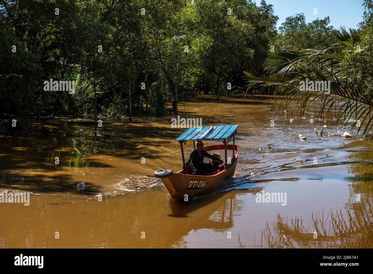Small boat sailing at Maludam river, Sarawak, East Malaysia, Borneo