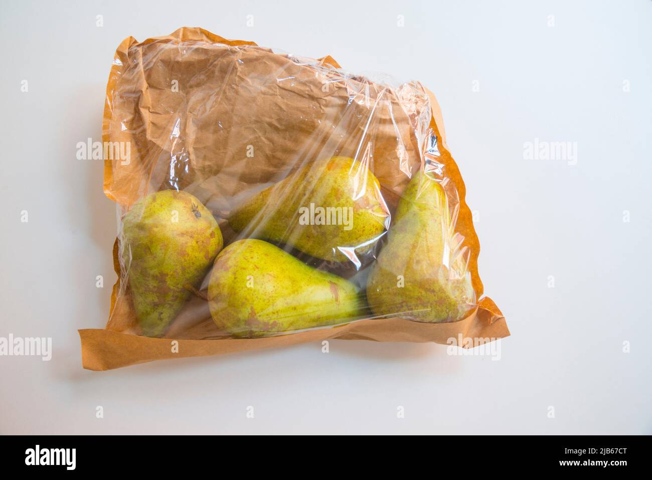 Four pears in a paper bag. Stock Photo
