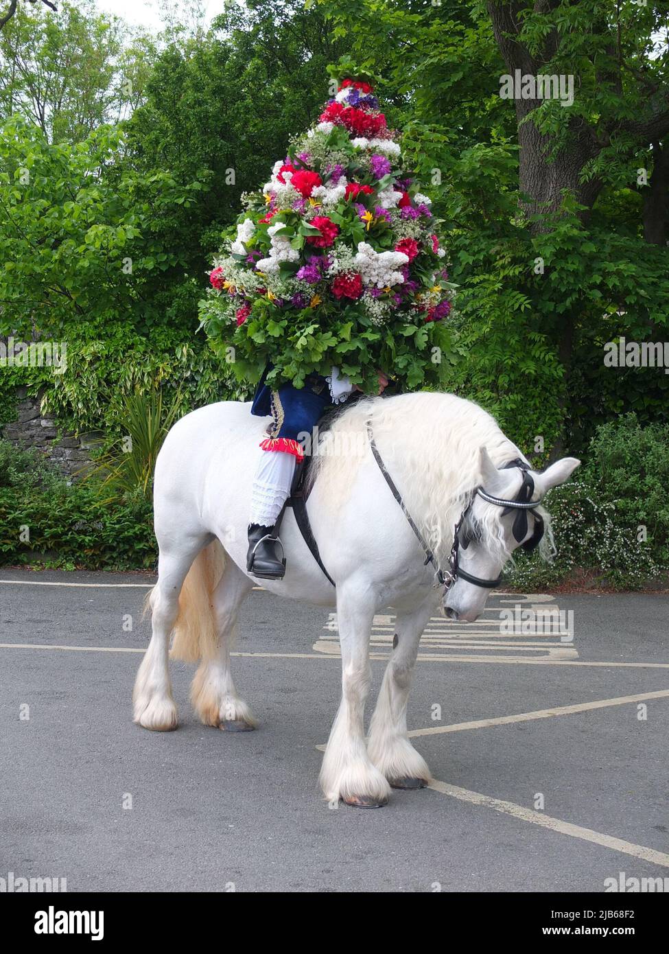 Portrait of the Castleton Garland King wearing a hooped garland of flowers on horseback during the ancient Castleton Garland Ceremony 2022 Stock Photo