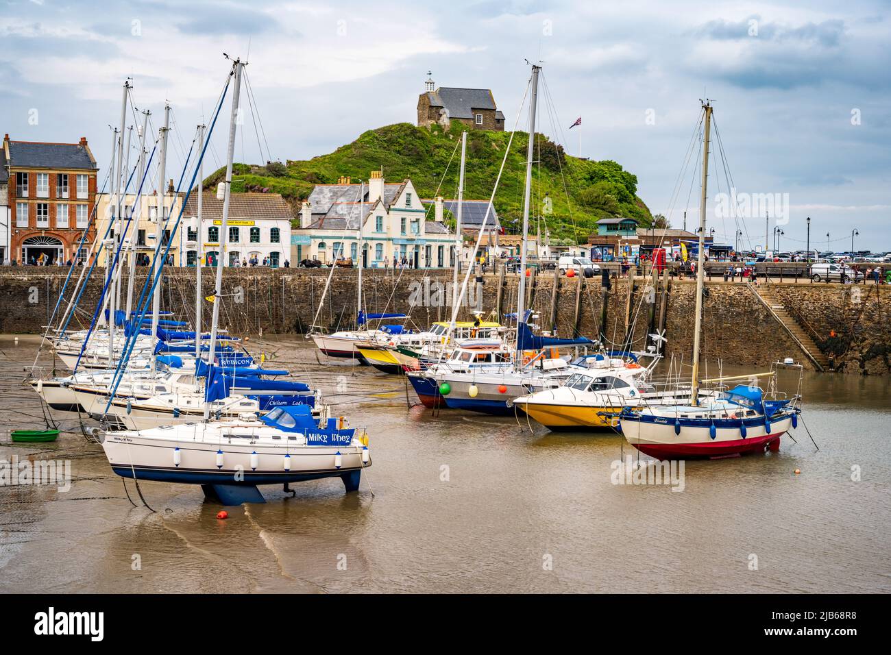 The harbour at the seaside resort town of Ilfracombe, Devon, UK.  St. Nicholas's Chapel on Lantern Hill overlooks the harbour. Stock Photo