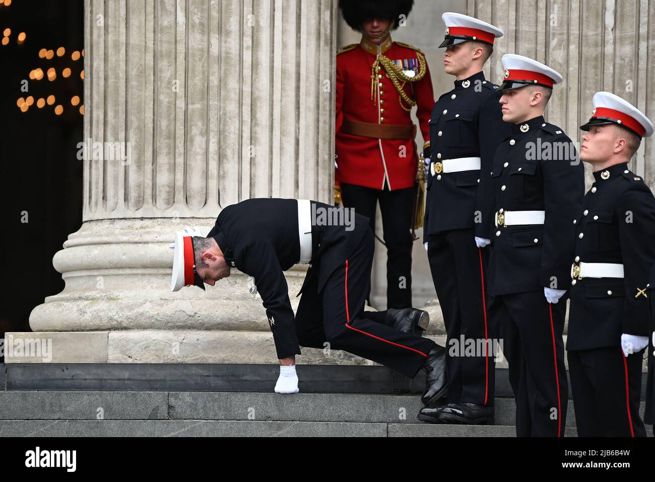 A member of the military stumbles during the National Service of