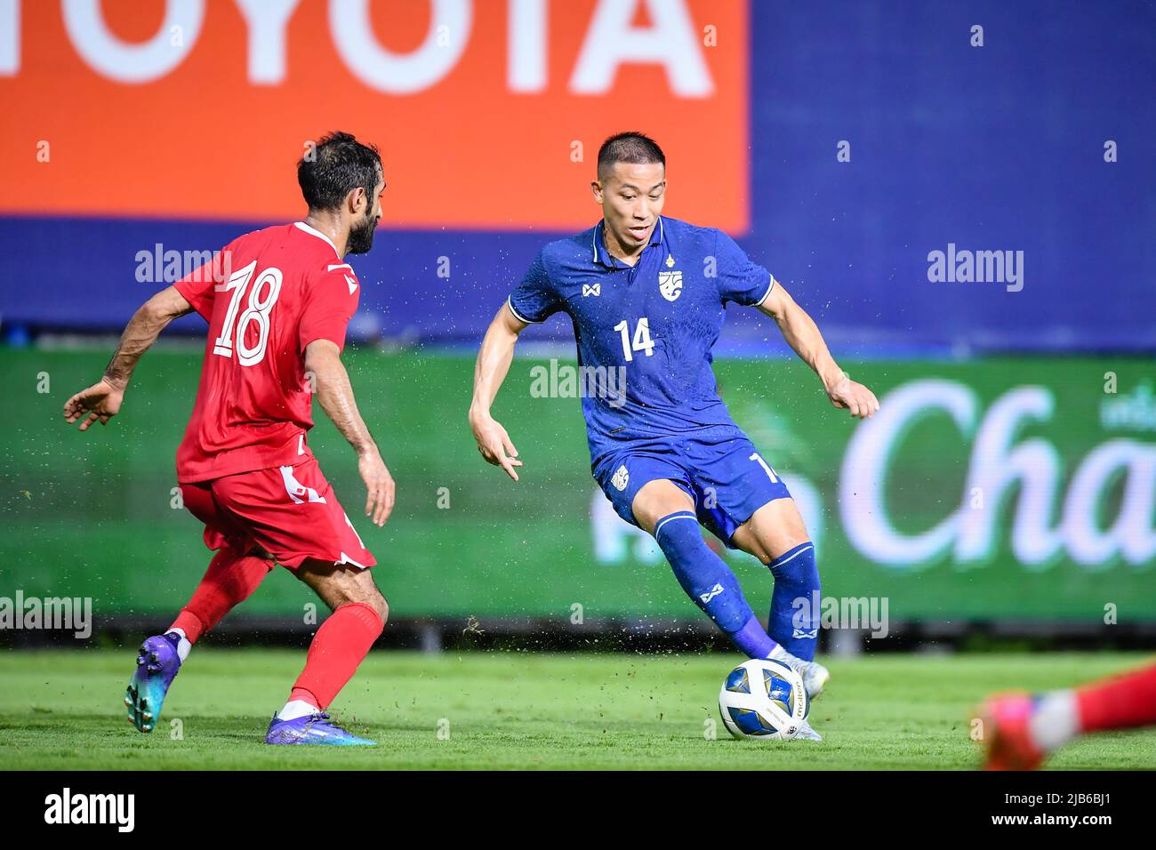 Pathompol Charoenrattanapirom (R) of Thailand and Ahmed abdulla Ali (L) of  Bahrain in action during the International Friendly match between Thailand  and Bahrain at Leo Stadium. Final score; Thailand 1:2 Bahrain. (Photo