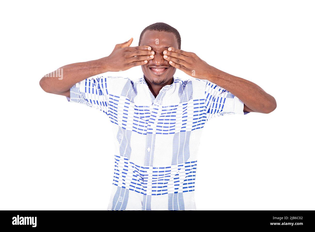 young happy man in shirt laughing with hands on face covering his eyes ...