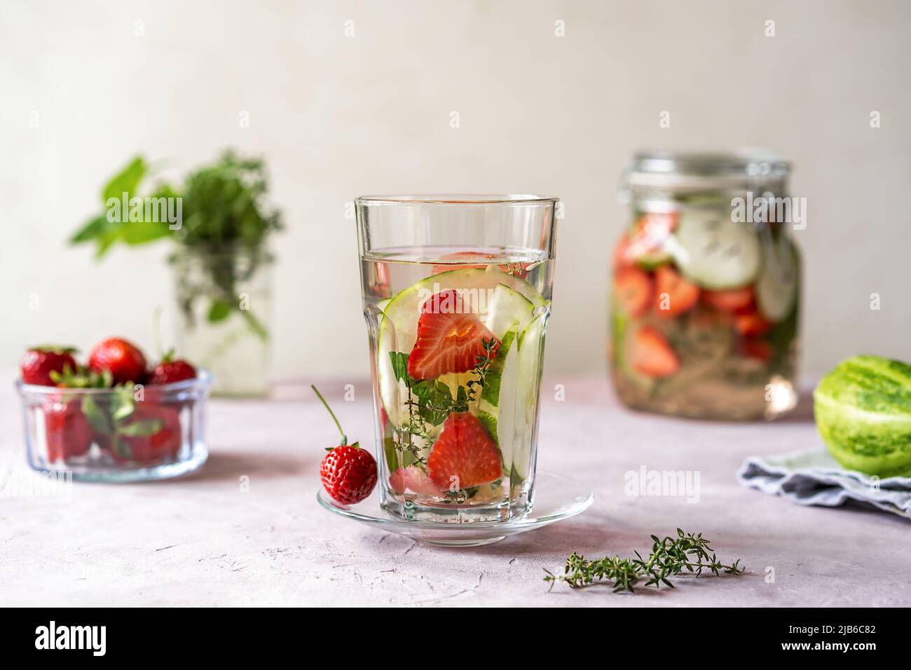Infused water with strawberry and meloncella that is hybrid of cucumber and melon, thyme, mint.  Stock Photo