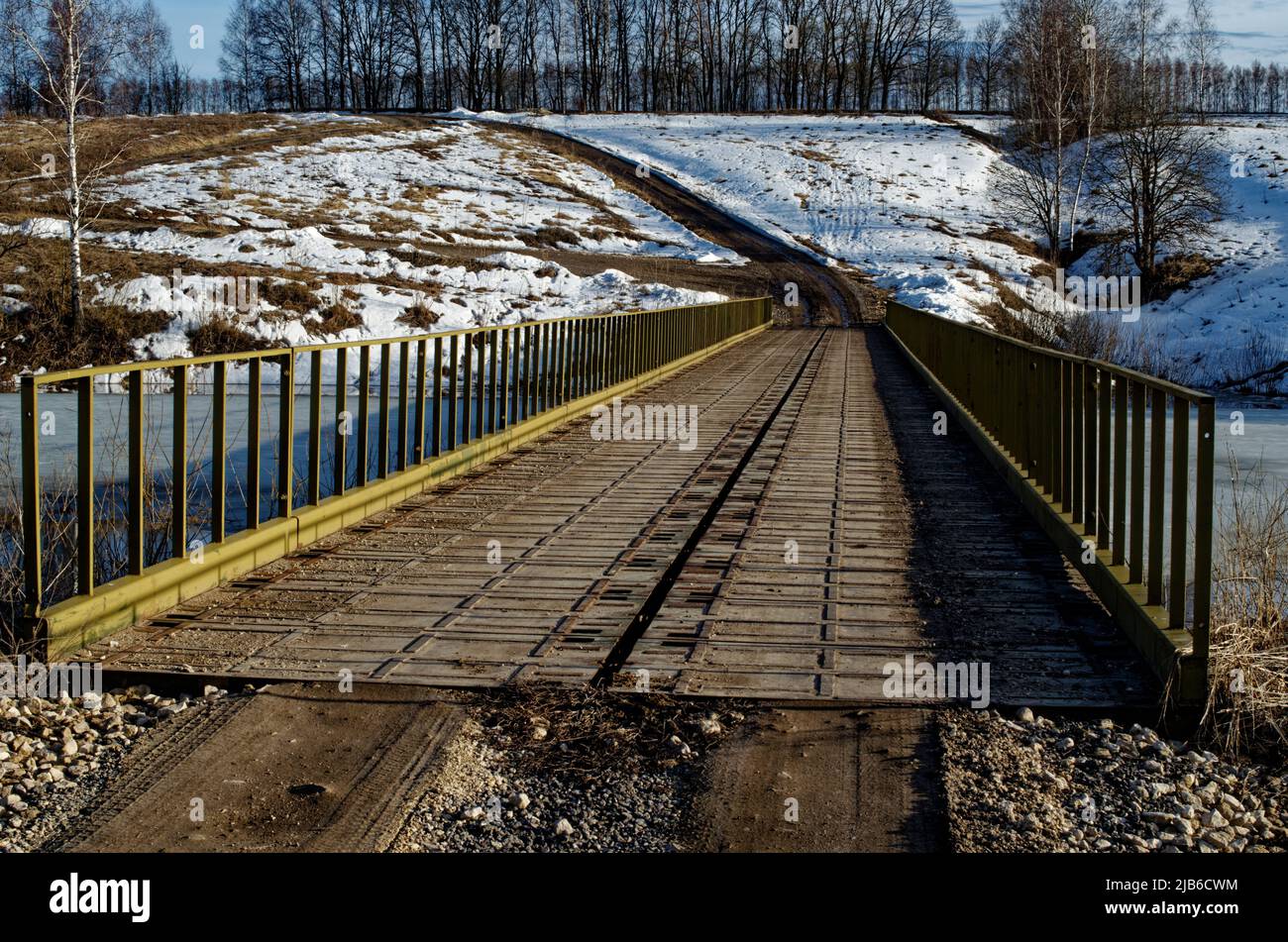 a small road bridge over the river, in early spring Stock Photo