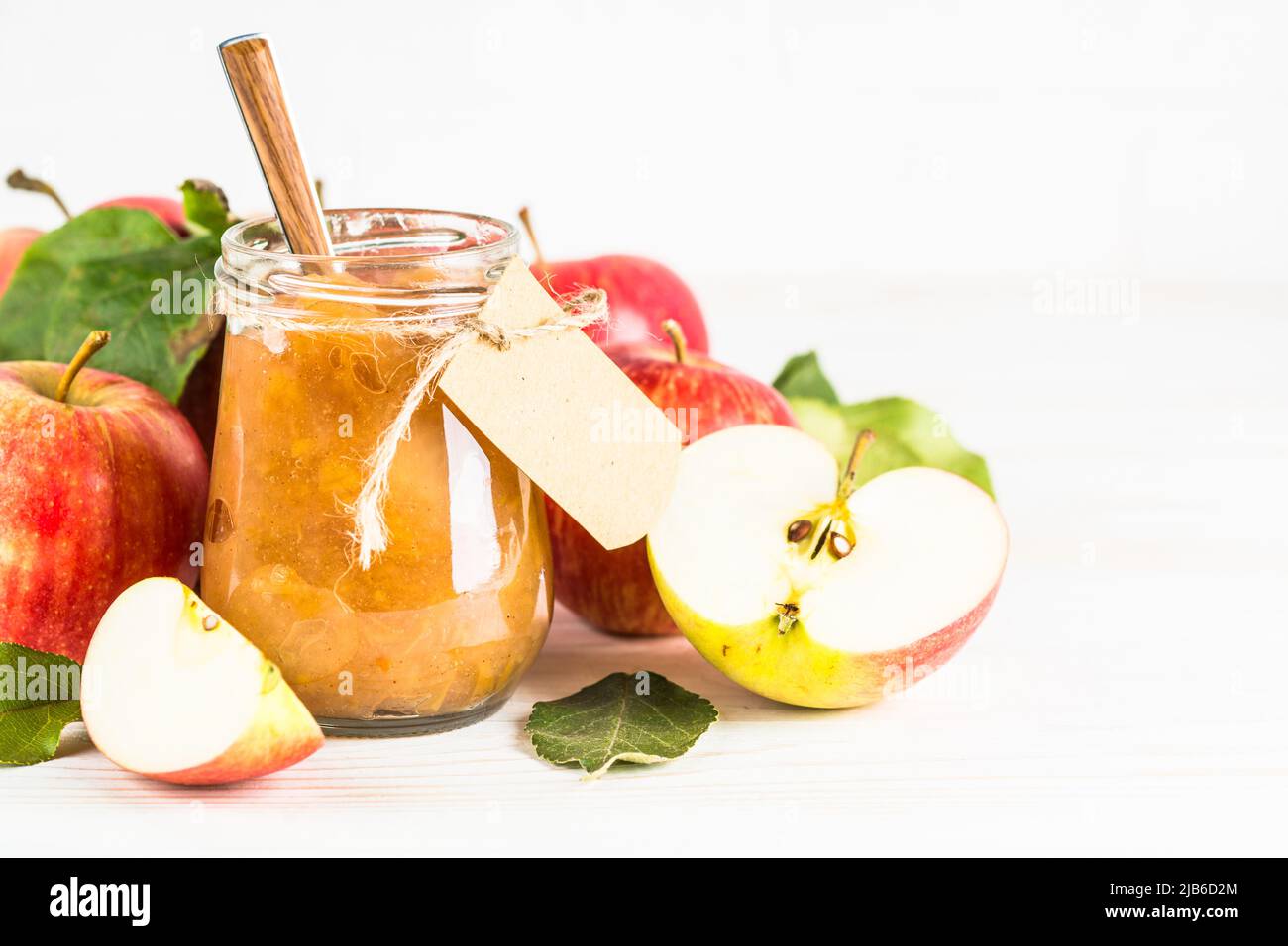 Apple jam with fresh apples on white background. Stock Photo