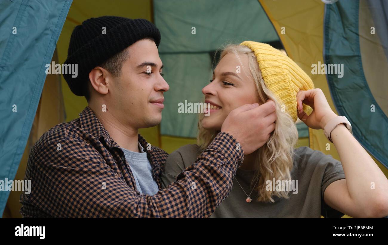 Romantic couple camping outdoors and sitting in a tent. Happy Man and ...
