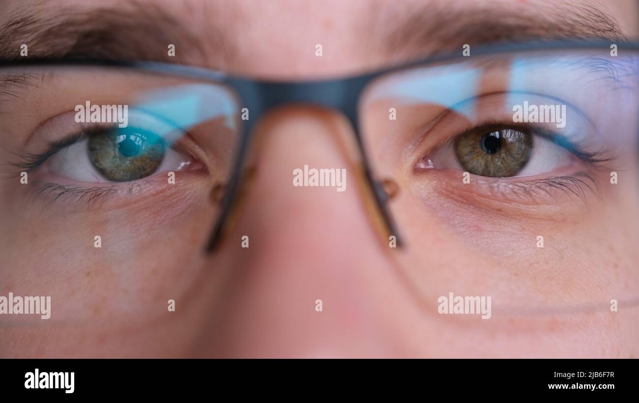 Close up of man's face with glasses. Boy opening his beautiful green