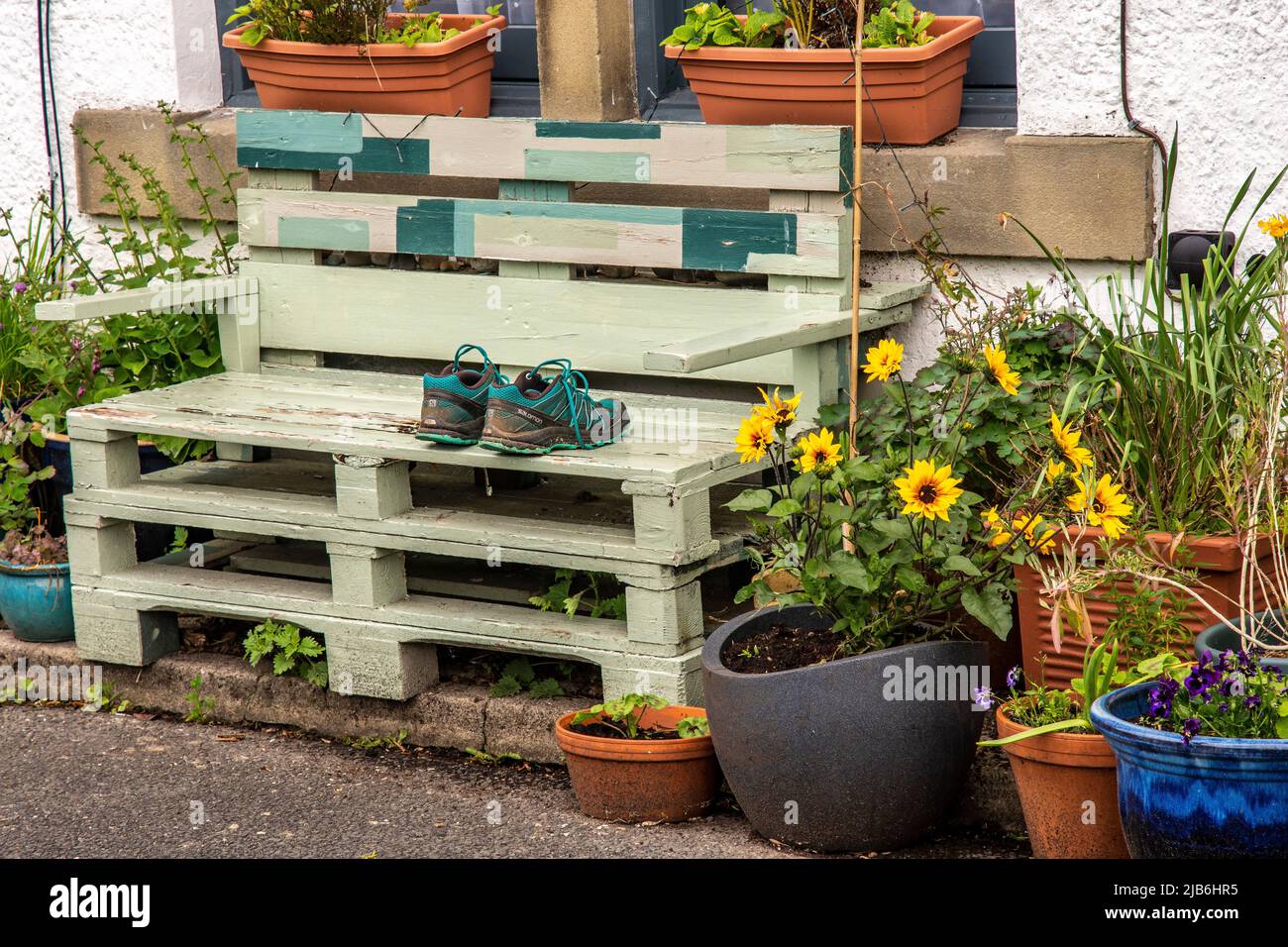 Upcycling wooden pallets to make  a bench used by walkers to rest their weary feet Stock Photo