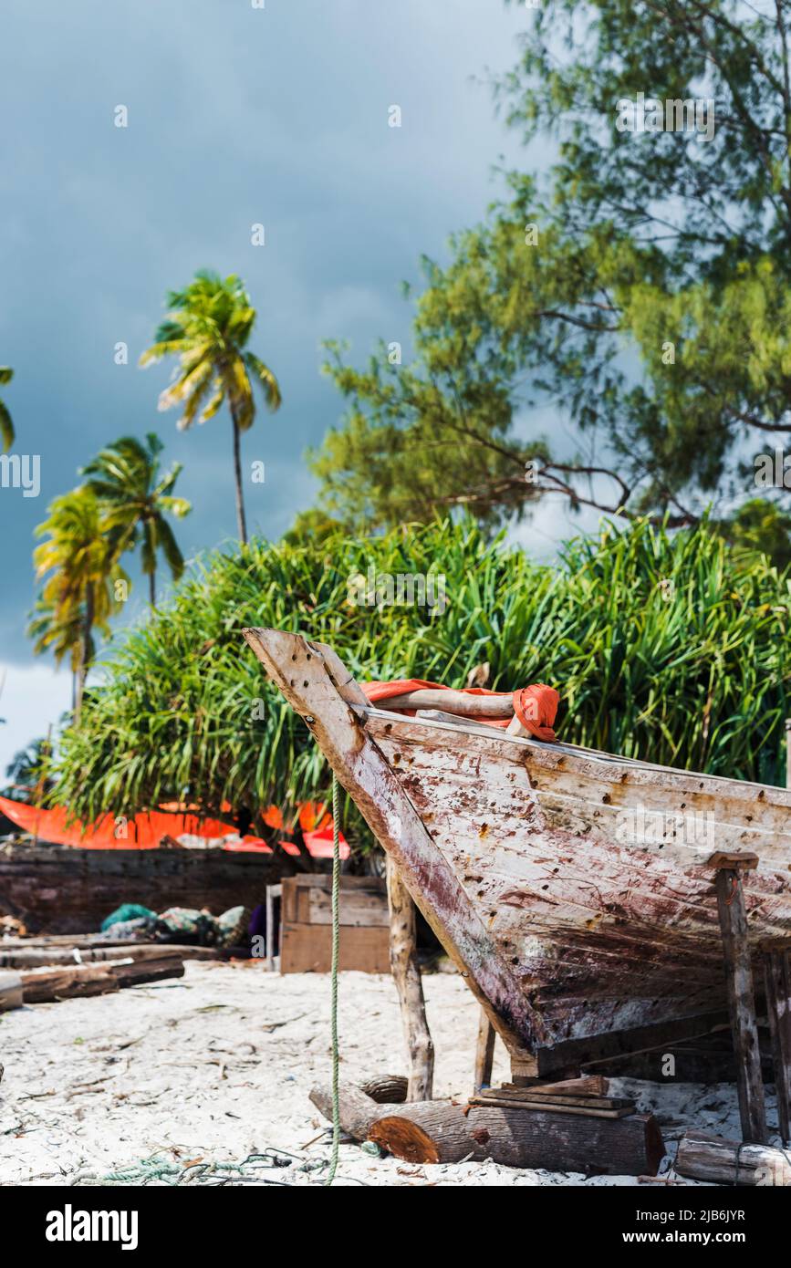 old wooden fishing boat with paddles on a beach Stock Photo - Alamy