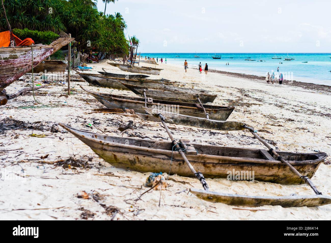 old wooden fishing boats with paddles on a beach Stock Photo - Alamy