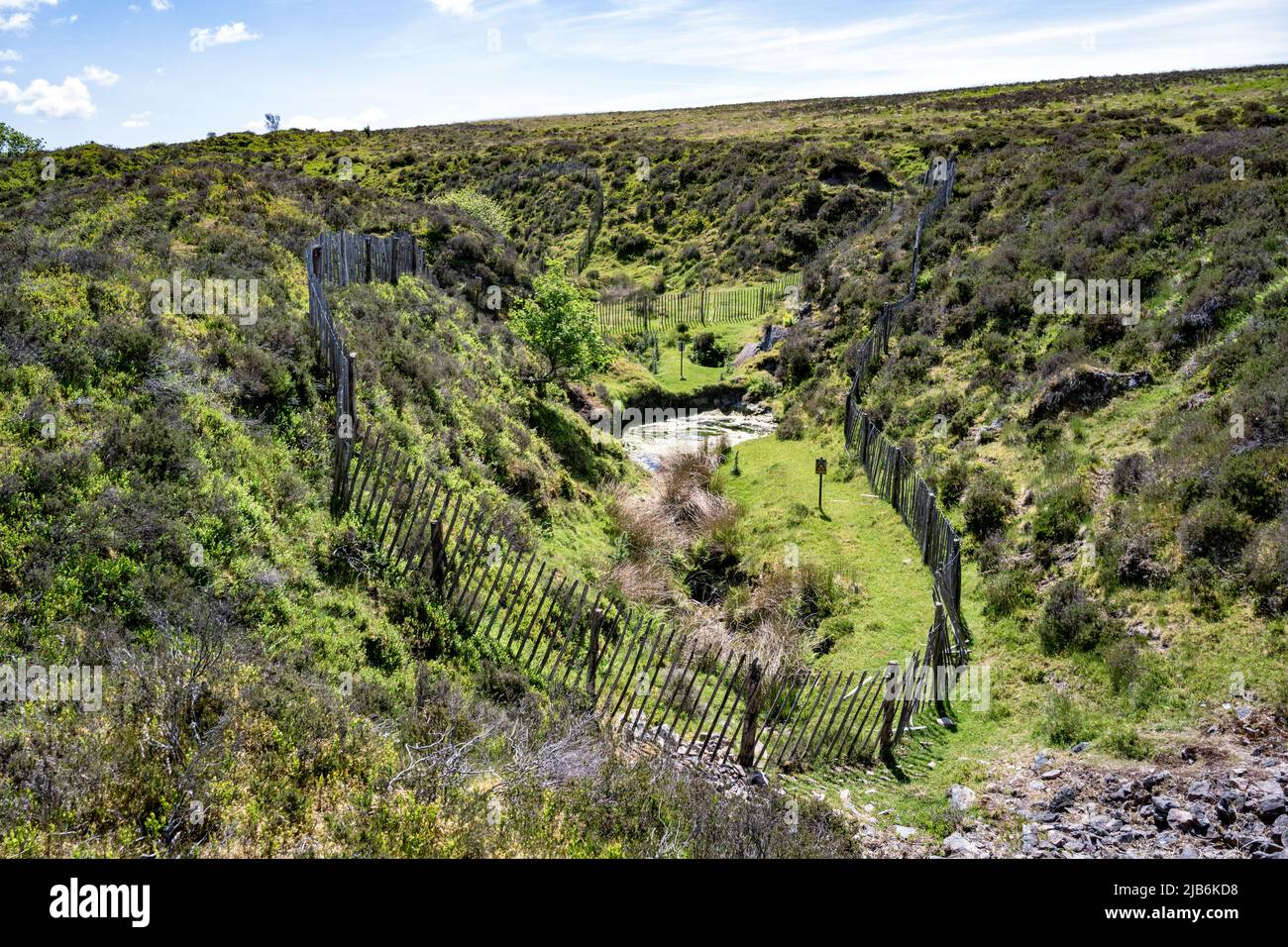 Abandoned tin mine pit, once part of the Vitifer Mine near Birch Tor, Dartmoor, Devon, UK.  Area is fenced off for safety. Stock Photo