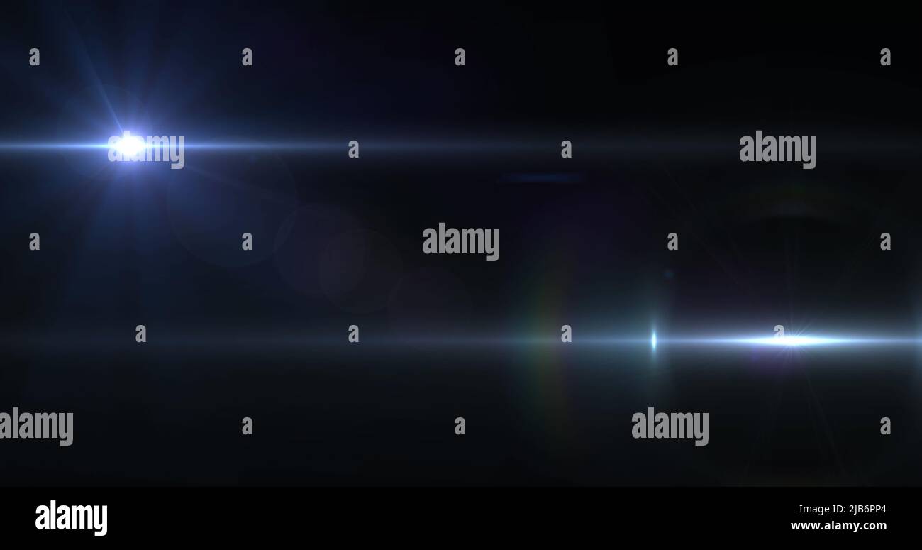 Image of two beams of white light moving across dark background Stock Photo