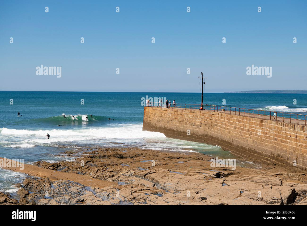 Surfers paradise, very sunny warm with large waves Porthleven Cornwall paddle boards and swimmers 03-06-22 Credit: kathleen white/Alamy Live News Stock Photo