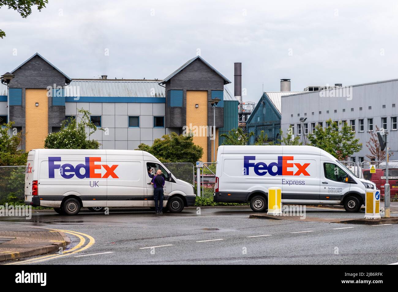 Two FedEx delivery vans parked in Lincoln, Lincolnshire, UK. Stock Photo