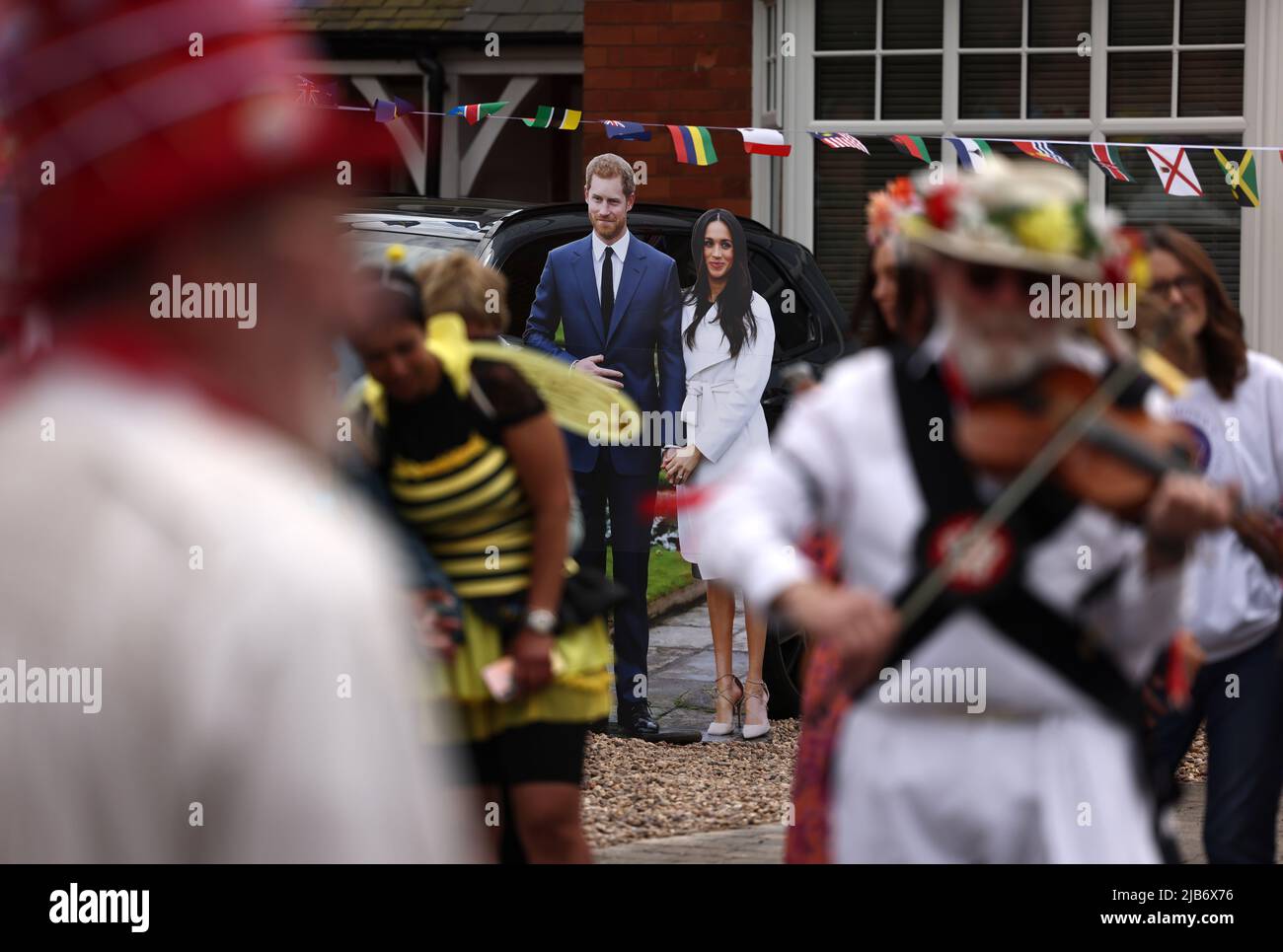 Leicester, Leicestershire, UK. 3rd June 2022. A cardboard cut out of Prince Harry and Meghan is seen behind Leicester Morris Men during the Knighton Church Road street party to celebrate the Queen's Platinum Jubilee. Credit Darren Staples/Alamy Live News. Stock Photo