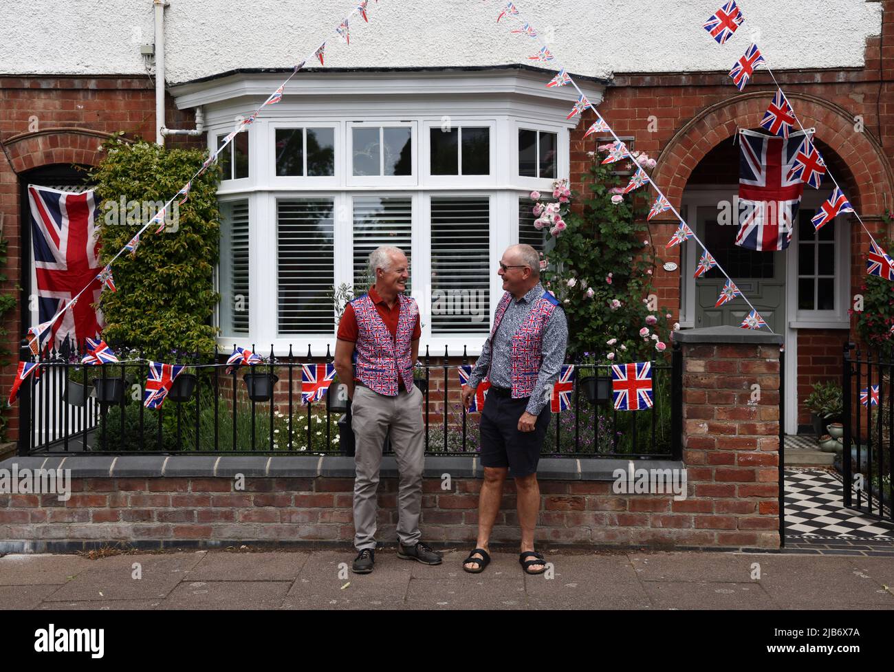 Leicester, Leicestershire, UK. 3rd June 2022. Men wearing Union Jack waistcoats stand outside a decorated house during the Knighton Church Road street party to celebrate the Queen's Platinum Jubilee. Credit Darren Staples/Alamy Live News. Stock Photo