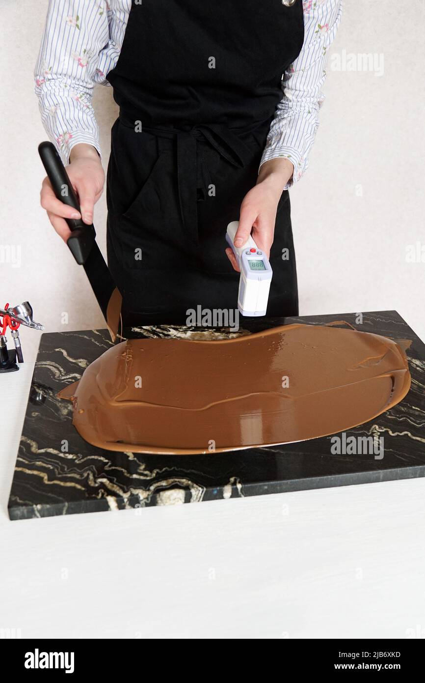 Closeup hands of professional female confectioner cooking dessert