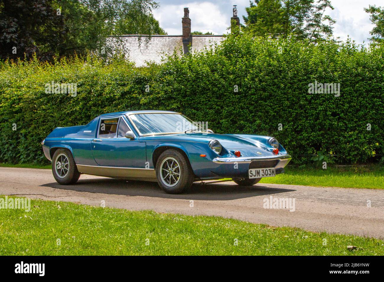 1973 70s seventies blue British Lotus Europa 1558 cc petrol sports car arriving in Worden Park Motor Village for the Leyland Festival, UK Stock Photo