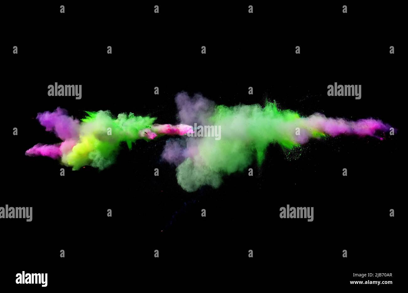 Various multicolored forms of powder paint explode in front of a black