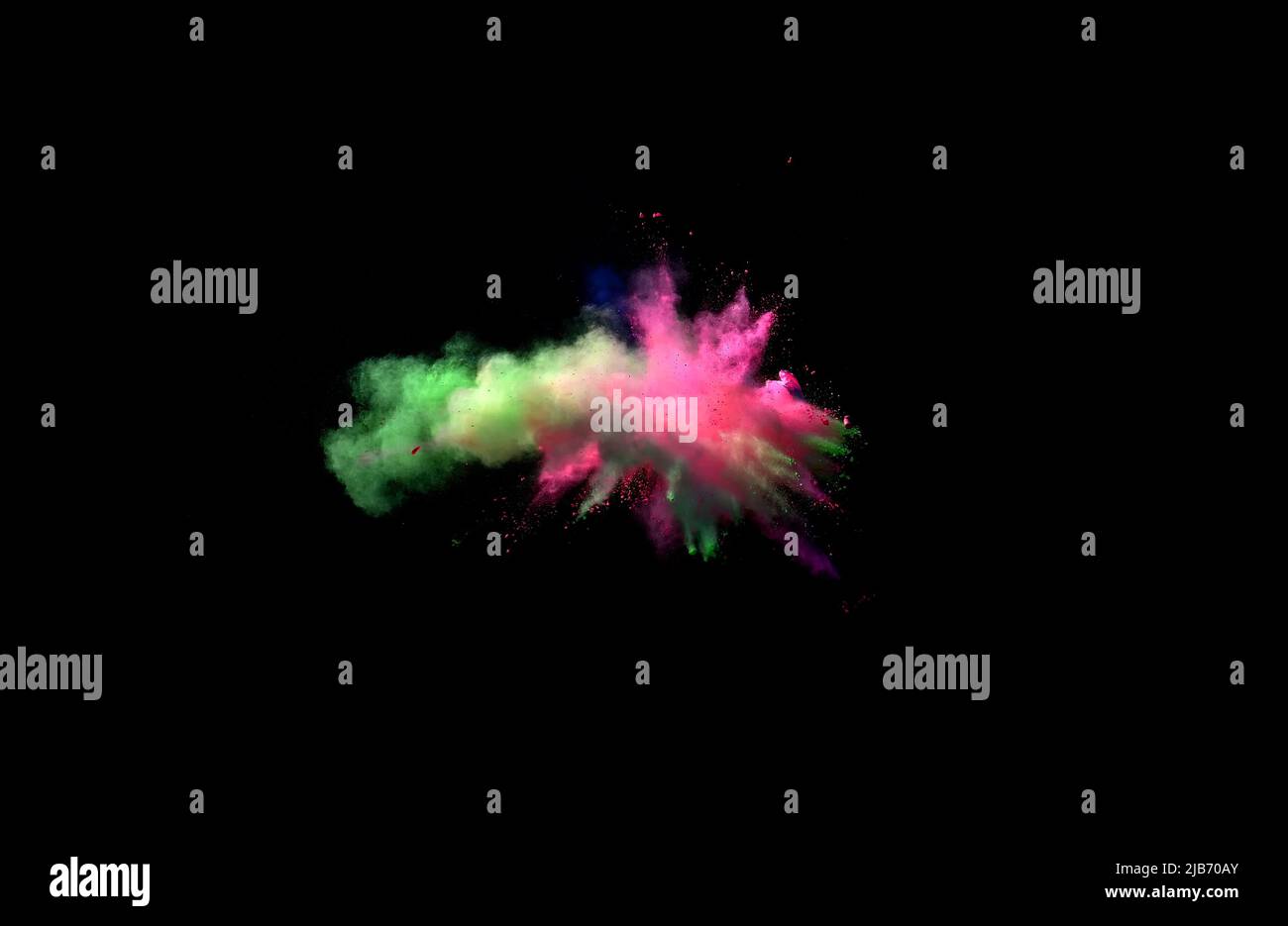 Various multicolored forms of powder paint explode in front of a black ...