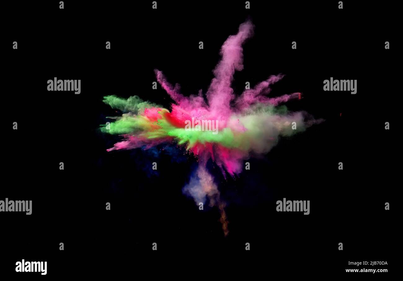 Various multicolored forms of powder paint explode in front of a black ...