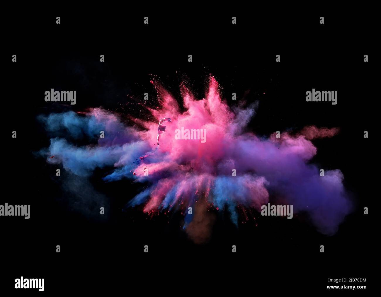 Various multicolored forms of powder paint explode in front of a black ...