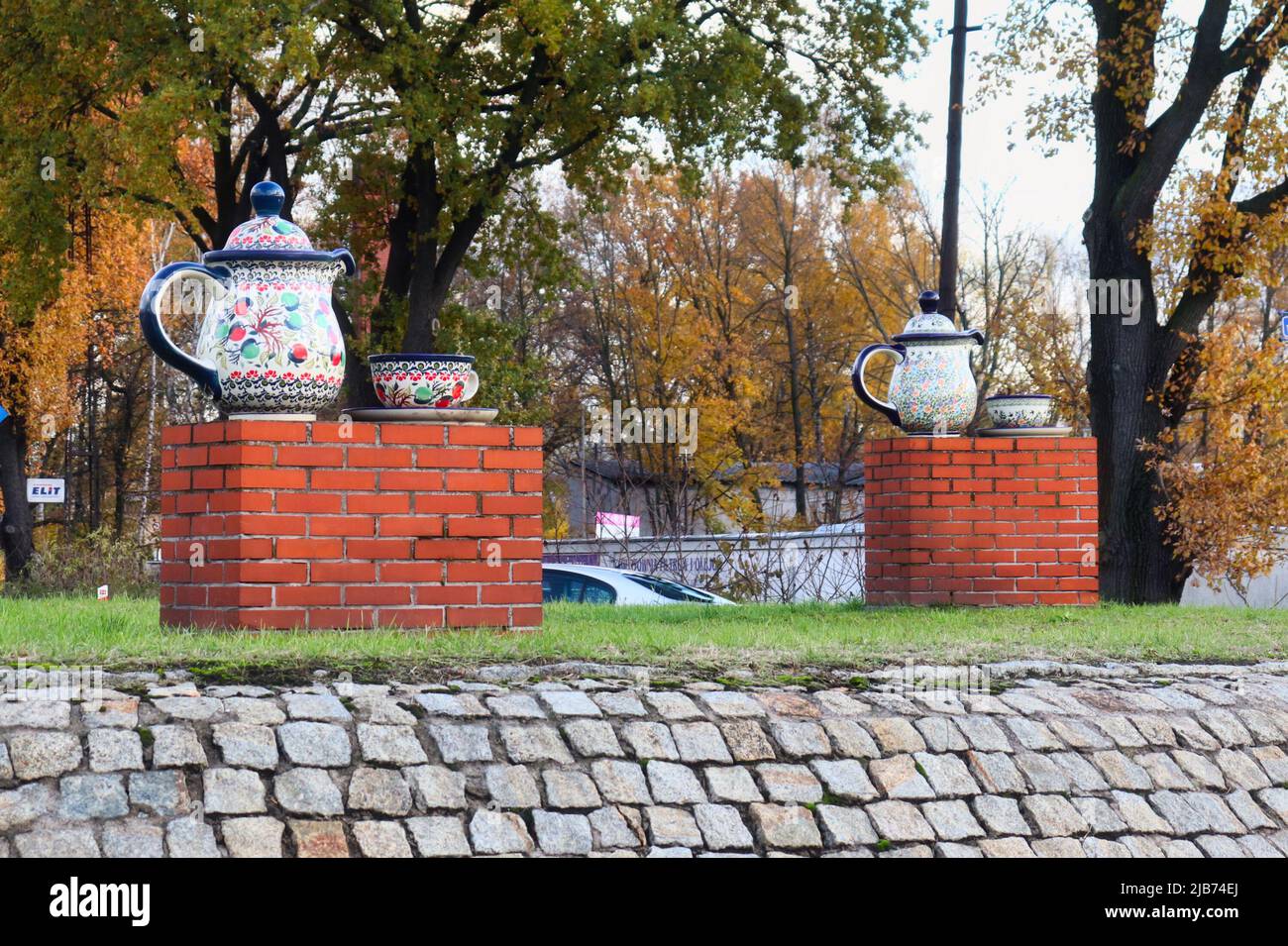 Pottery tea pots and cups decorate a roundabout in the town of Boleslawiec, Poland on a fall day. Stock Photo