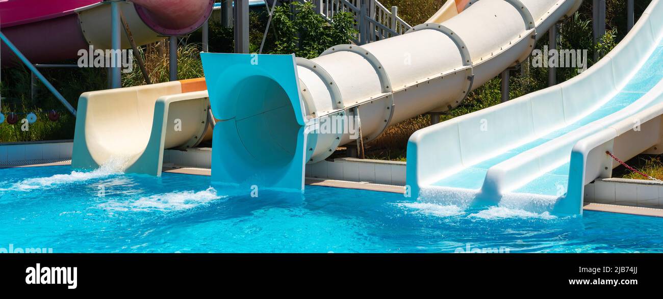 Aqua slides in the water park in front of the pool Stock Photo