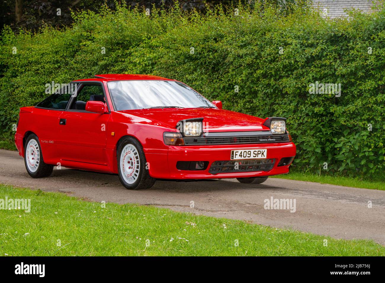 1989 80s eighties TOYOTA four-wheel drive, 1998 cc petrol sports coupe with flip up Headlights, arriving in Worden Park Motor Village for the Leyland Festival, UK Stock Photo