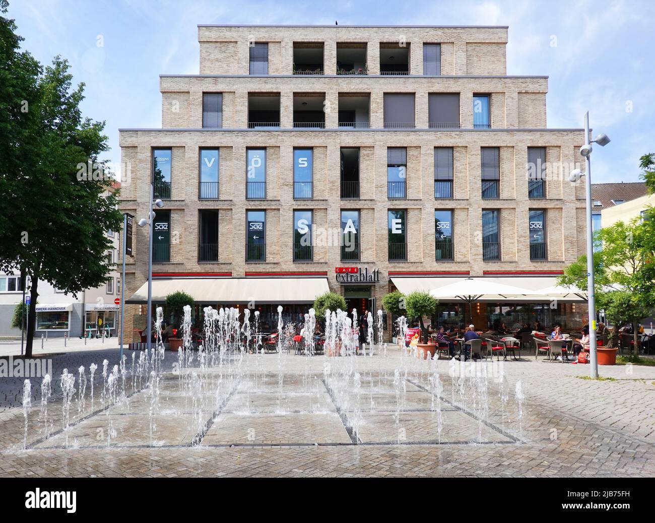 Fountain and Cafe Extrablatt at Am Marstall square in Hannover Germany in May 2022 Stock Photo