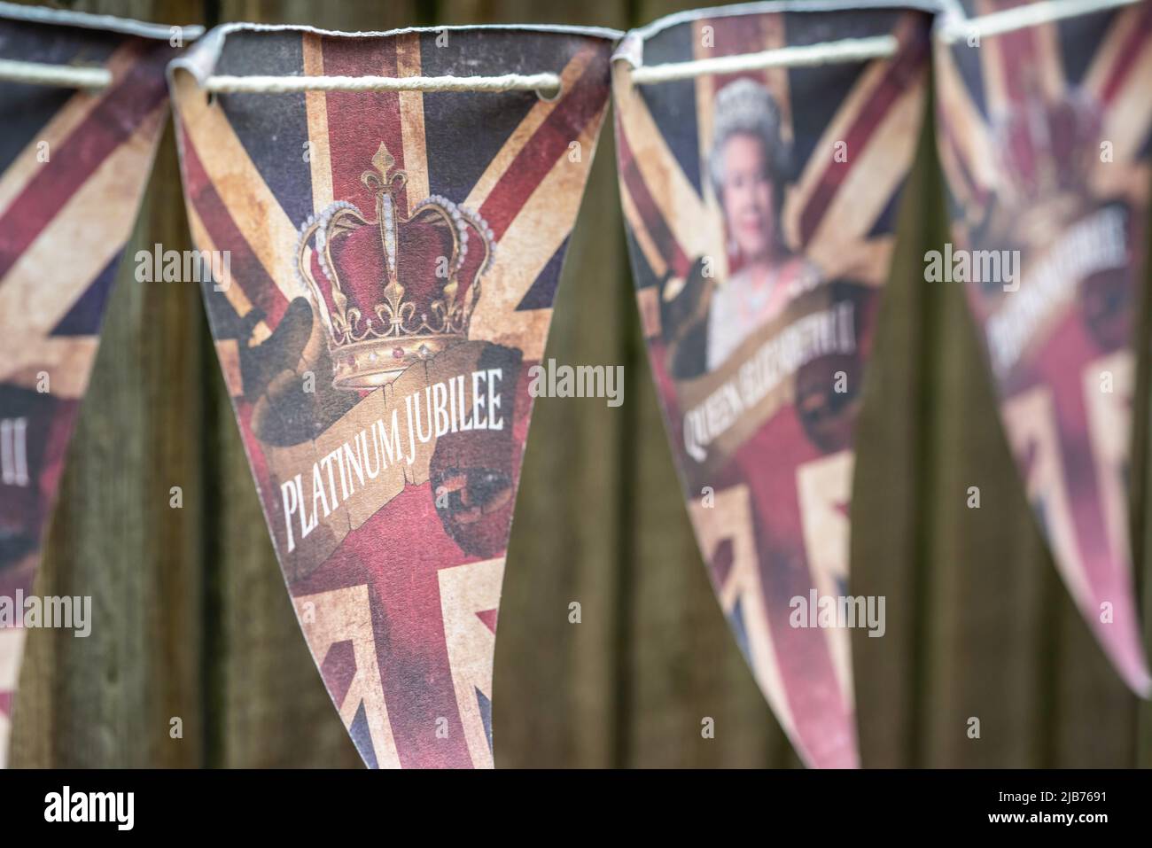 Platinum Jubilee bunting along a fence to celebrate Queen Elizabeth II's 70 years of reign, England, UK Stock Photo