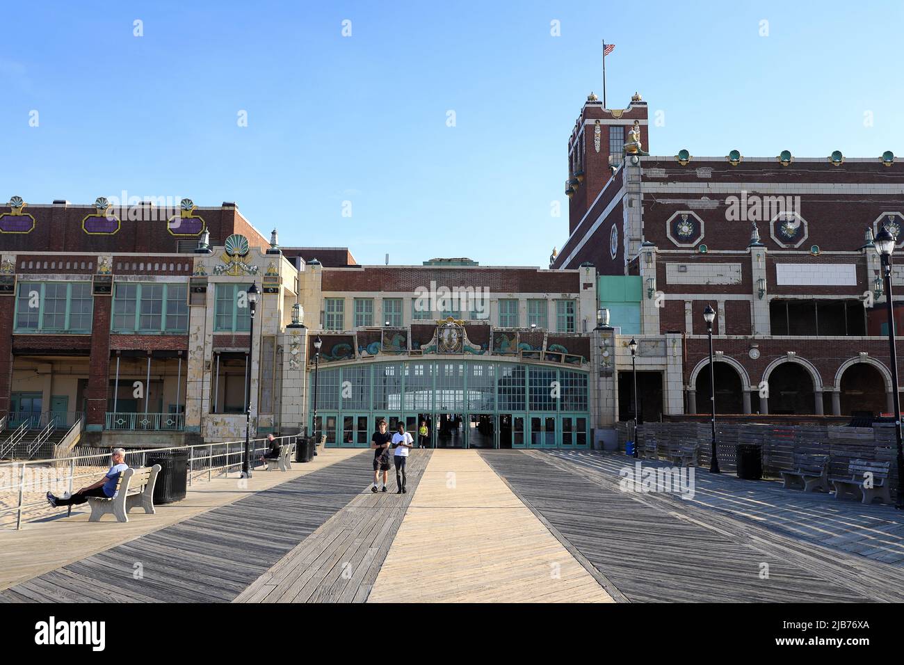 Visitors on Asbury Park Beach boardwalk with Convention Hall in the background.Asbury Park.New Jersey.USA Stock Photo