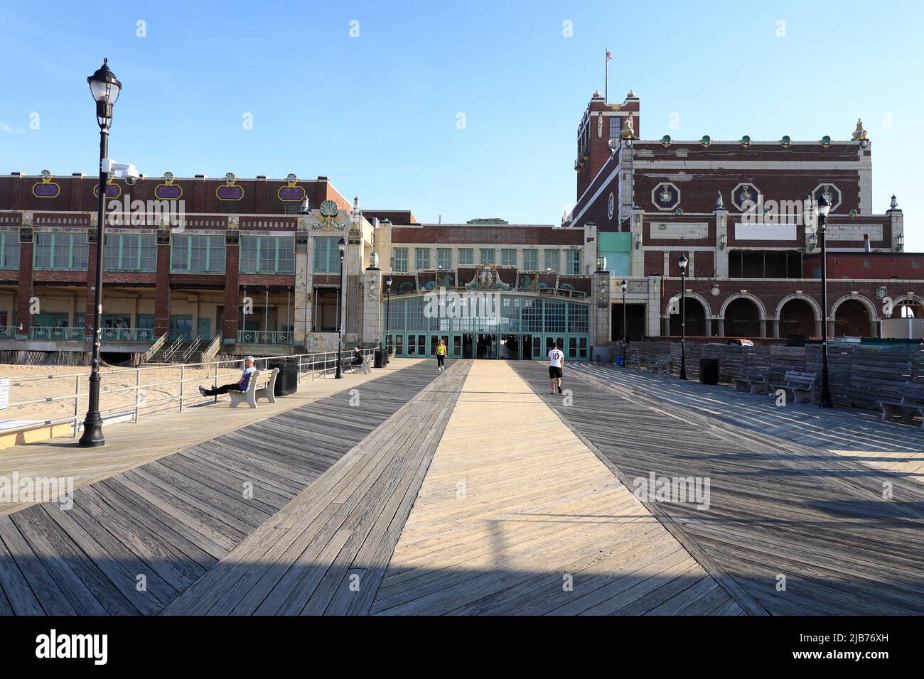Visitors on Asbury Park Beach boardwalk with Convention Hall in the background.Asbury Park.New Jersey.USA Stock Photo