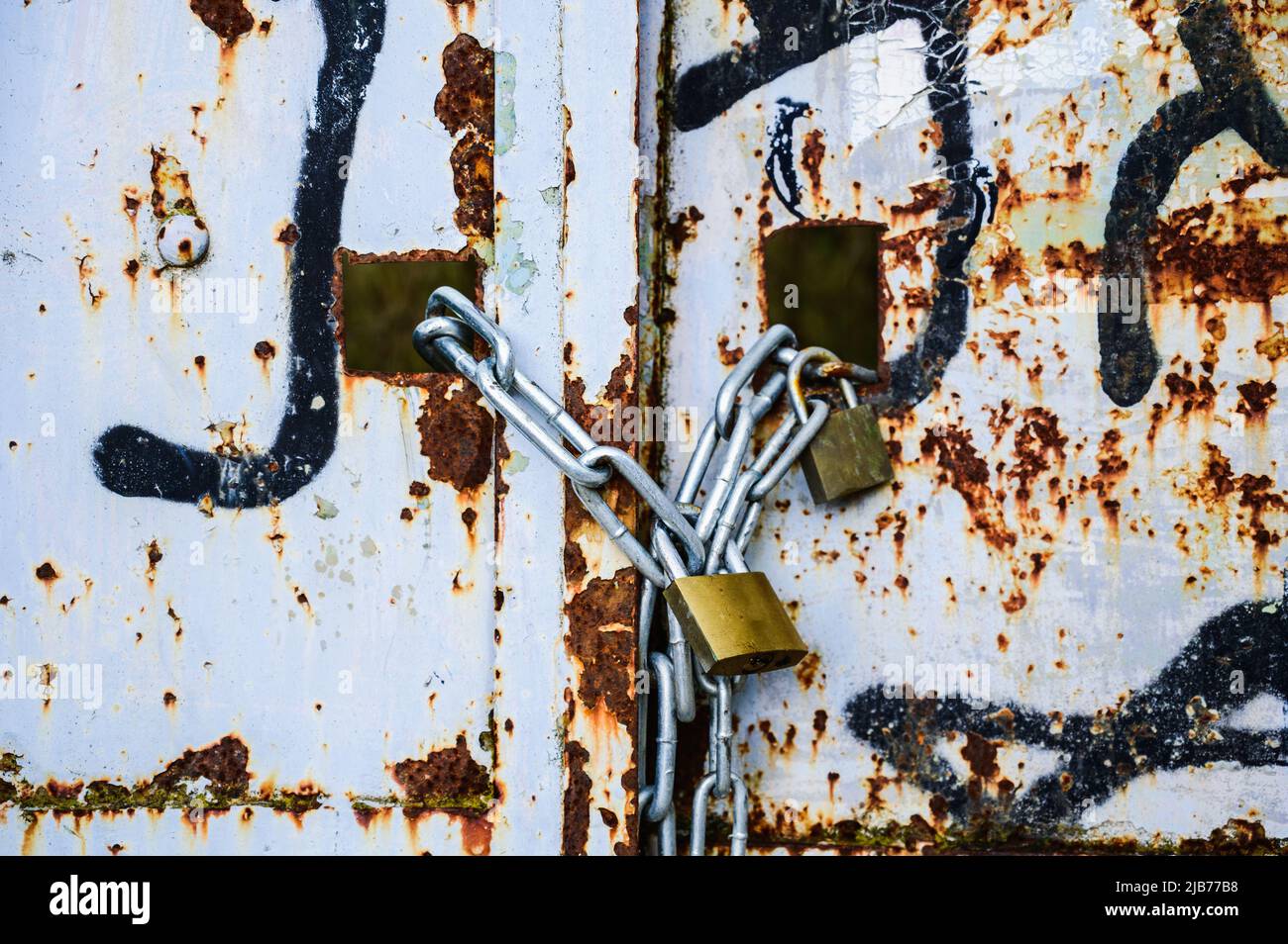 Rusty Lock Gate Rusty lock on the gate of a small gray container close-up. High quality ...