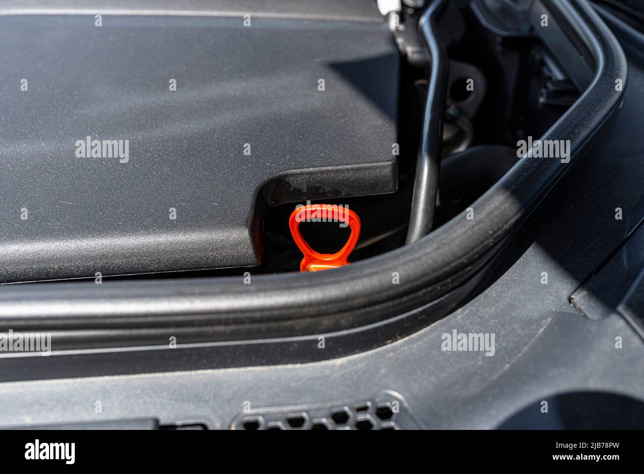 Dipstick for checking the oil level in a car engine in orange Stock