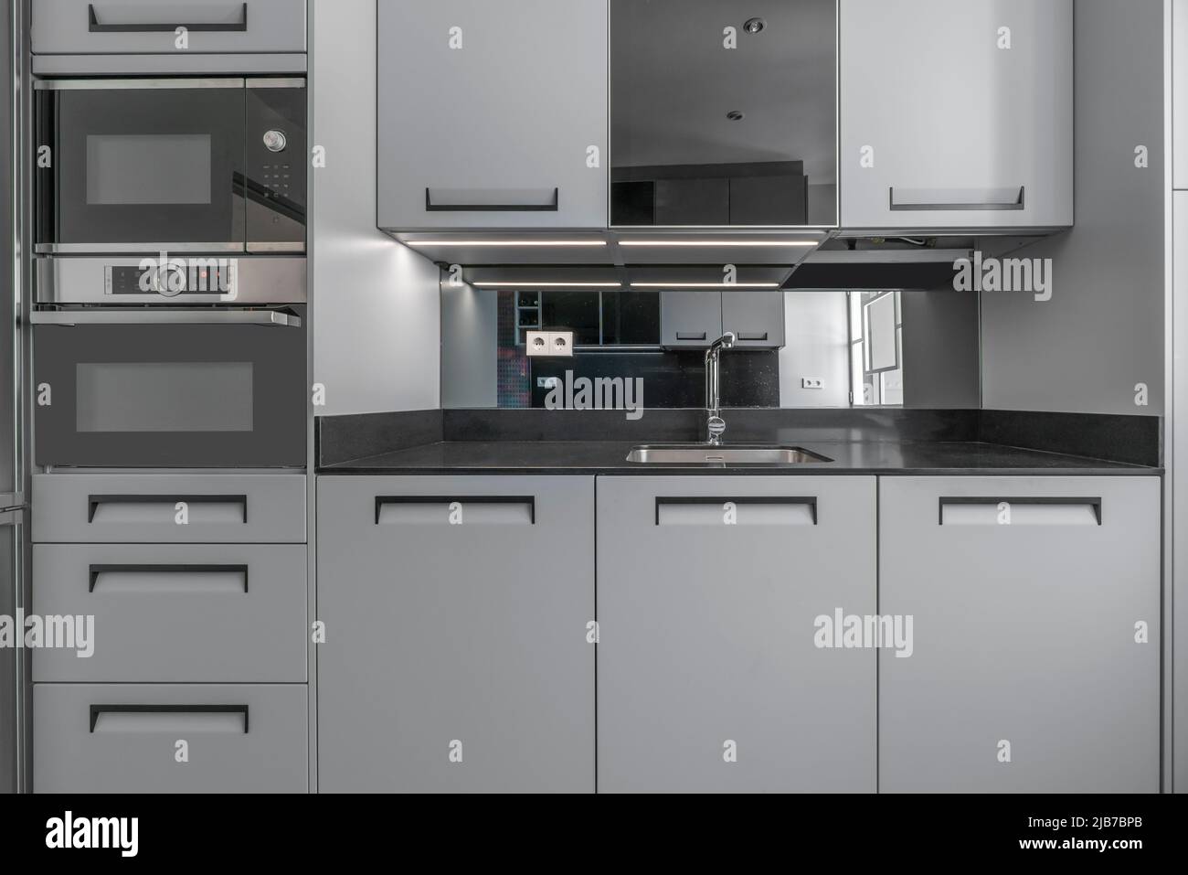 Kitchen front shot with newly installed gray and drawers with