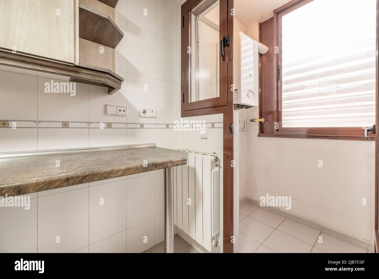 Kitchen corner with wooden worktop, white aluminum radiator, red