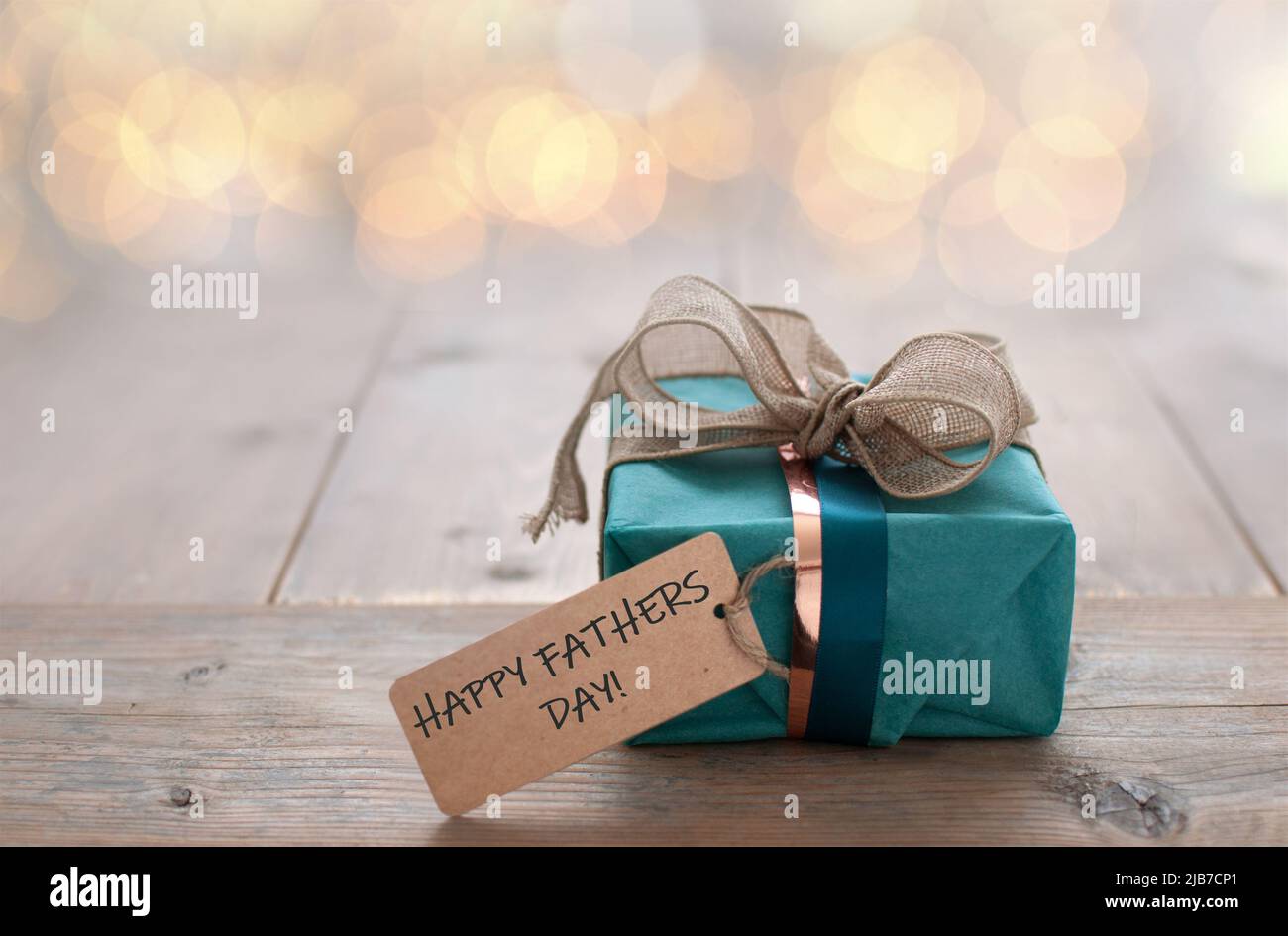 Wrapped gift with father day greeting label attached Stock Photo
