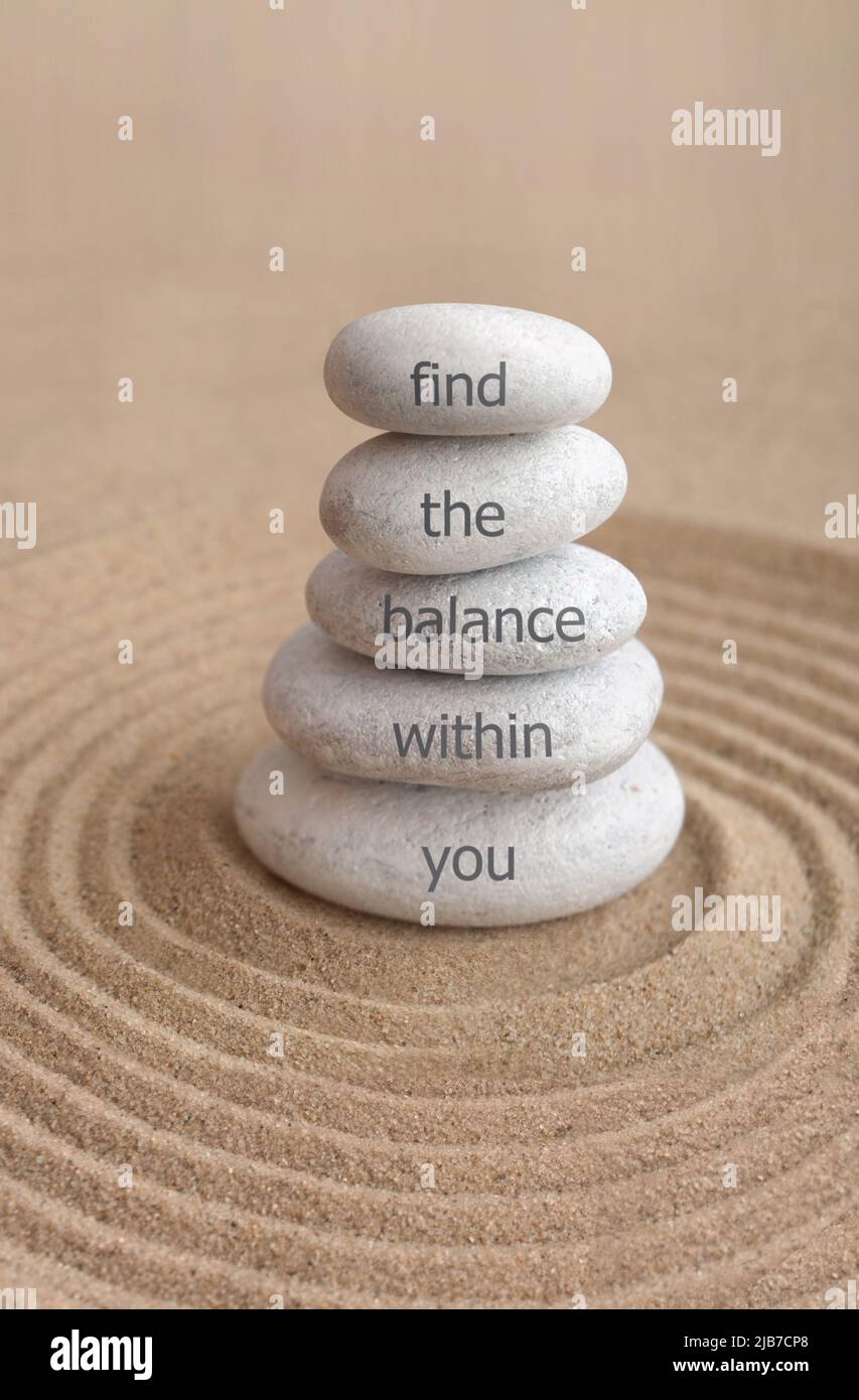 Yoga zen stones on top of one another with inspirational saying find the balance within you Stock Photo
